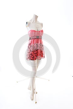 Pink dress long top mini dress on mannequin full body shop display. Woman fashion styles, clothes on white studio background...