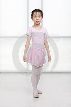 Pink dressed Asian girl in a ballet pose