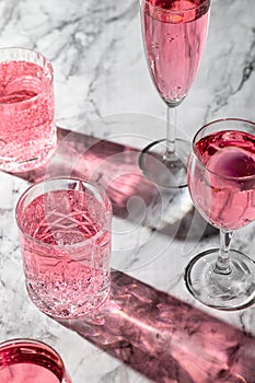 Pink drink in the different glasses