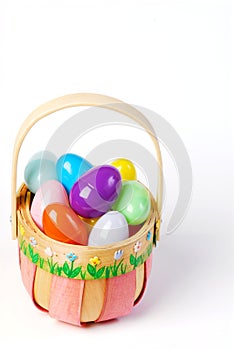 Pink Easter basket with colorful eggs