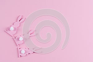 Pink Easter bunnies on pink background, easter greeting card, top view with copy space