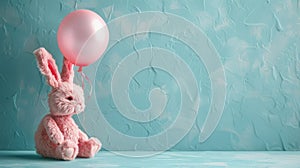 Pink Easter bunny and pink balloon on a blue background