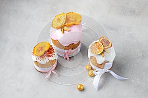 Pink easter cakes decorated by ribbons and orange chips