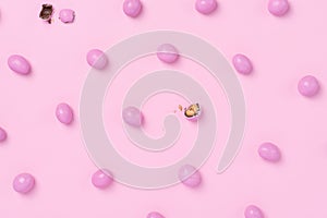 Pink easter dragee on a pink background. Sweet candies in the shape of eggs covered with pink glaze photo