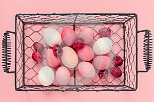 Pink easter eggs in basket. Top view