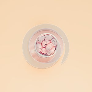 Pink easter eggs in coffee cup. Easter holiday background