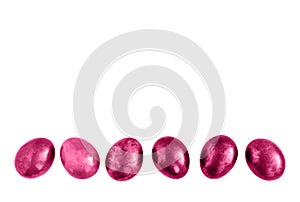 Pink Easter eggs in a row on isolated white background.