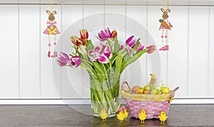 Pink Easter Eggs and Tulips Flowers  on a  Wooden Background