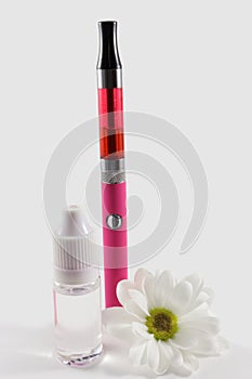 Pink electronic cigarette and bottle of liquid, decorated with white flower