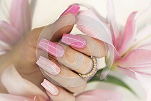 Pink elongated nail extension.