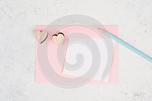 Pink envelope with hearts, empty copy space, blue pencil, valintines day greeting card, romantic mail, love photo