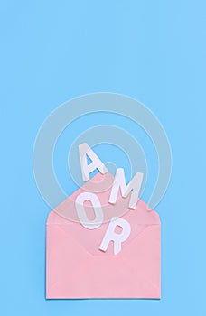 Pink envelope and text AMOR on a light blue background