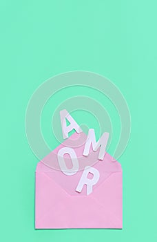 Pink envelope and text AMOR on a light green background