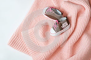 Pink exquisite plaid. Baby`s tiny sneakers