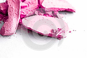 Pink eye shadow powder as makeup palette closeup isolated on white background, crushed cosmetics and beauty texture