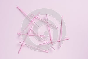 Pink eyelash brushes on a pink background