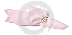 Pink fabric napkin with decorative ring for table setting on white background