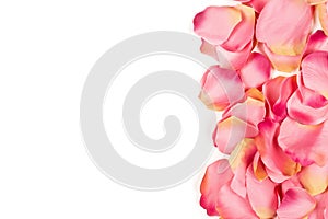 Pink fabric rose petals border over red background top view from above - marriage, love, wedding or valentine`s day background