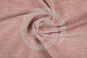 Pink fabric texture - close-up of a piece of crushed and twisted brown linen