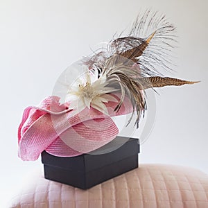 Pink fashion races hat with flower and feathers photo