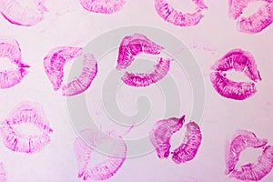 Pink female lip prints on white background. Kisses, smacks, lipstick prints. photo