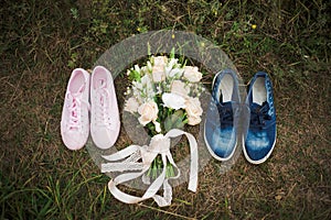 Pink female trainers shoes and blue male trainers shoes