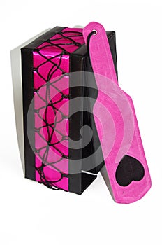 Pink fetish paddle with box on white