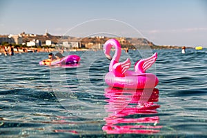 Pink flamengo inflatable on the sea