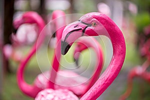 Pink flamingo statues in a home garden.