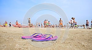 Pink flip flop on an Italian beach on a sunny summer