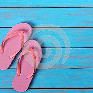 Pink flip flop sandals summer beach wood background