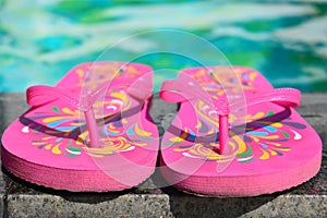 Pink flip flops at the pool. Vacation at the sea