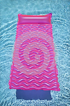 Pink float in empty pool.