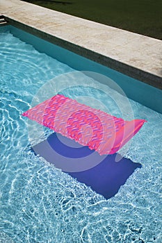 Pink float in swimming pool.