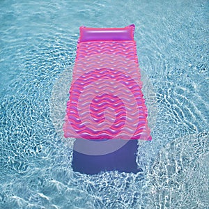 Pink float in swimming pool.