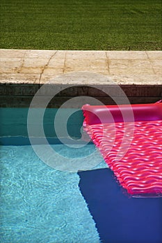 Pink float in swimming pool.