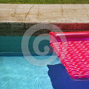 Pink float in swimming pool.