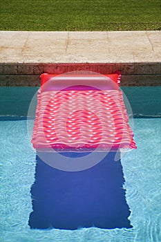 Pink float in swimming pool.