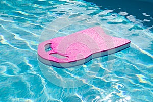 Pink floating board in the swimming pool.