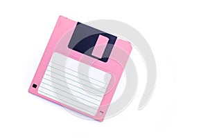 Pink floppy disk on white background
