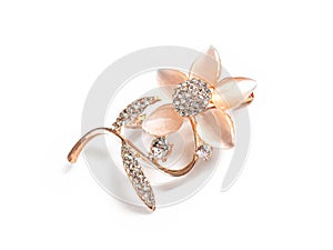 Pink flower brooch with cut stones on a white background