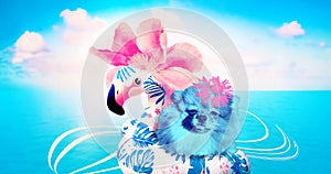 Pink flower and flamingo rubber ring on blue background. Summer minimal art collage. Concept of travel, holidays and