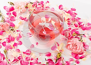 Pink Flower Tea with Carnation Petals. Hot Rose Drink in Glass Cup