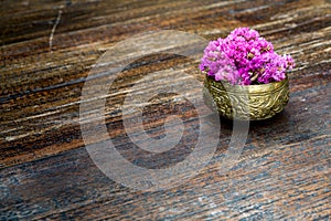 Pink flowers in brass bowl