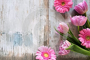 Pink flowers on gray vintage planks