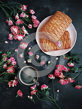 Pink flowers, puff pastries and coffee on a dark background, Bush roses, Blog style, Flatlay, Floral, Postcard photo