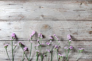 Pink flowers on table wooden background