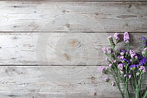 Pink flowers on table wooden background.Copy space for text on wood