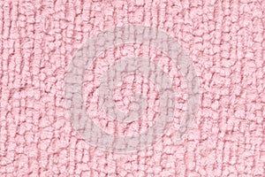 Pink fluffy background of soft, fleecy cloth. Texture of textile closeup