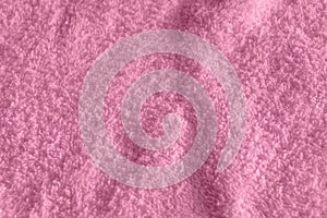Pink fluffy Terry towel, a simple example of the texture of a soft, fleecy fabric, a background of folds